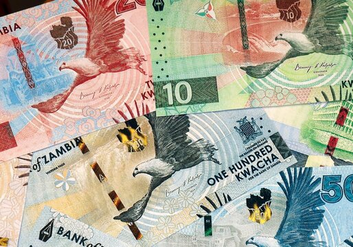 Zambian kwacha money bills in pile on table. Zambia ZMW currency cash close up