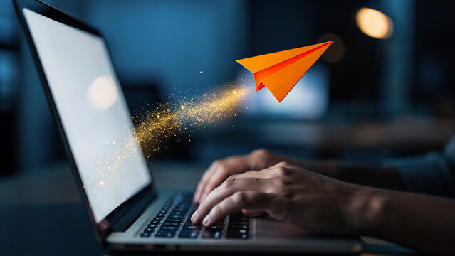 Orange paper airplane flying out of a laptop screen with golden sparks trail, perfect for digital communication, startup growth and creative ideas promotion