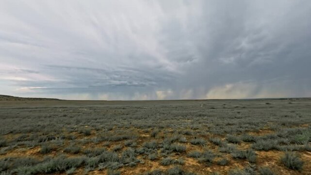 Off-road vehicle view of expansive grassland under dramatic stormy sky