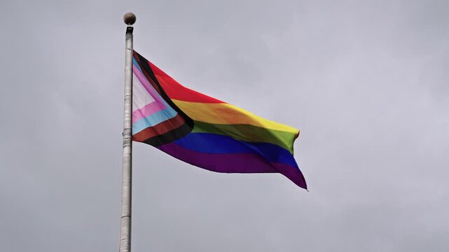 LGBT community. Tolerance and equality. World gay pride. Rainbow gay flag. Pride month. LGBTQ rainbow flag. LGBT rainbow flag waving against sky. Symbol of pride and LGBTQ. Colorful pride flag