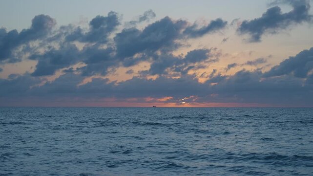 Sunset cloudy sky. Seascape at summer vacation. Skyscape with sea horizon. Horizon sunrise sea with ship. Sunrise seascape. Romantic summer vacation seascape. Sea sunset horizon. Golden hour