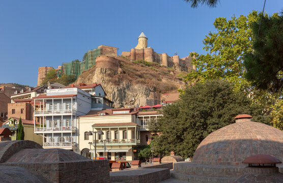 View of Narikala Fortress overlooking the historic district with traditional houses and churches in Tbilisi, Georgia.