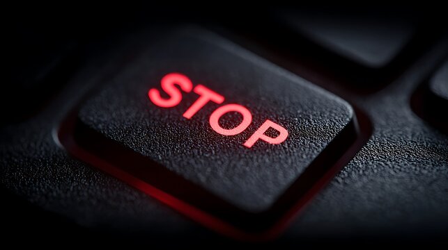 A high-resolution shot of a STOP key with a focus on its red hue