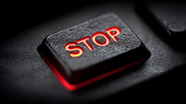 A high-resolution shot of a STOP key with a focus on its red hue
