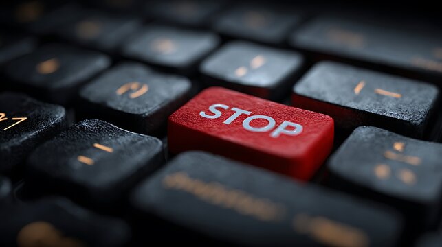 A close-up shot of a keyboard, the red STOP key standing out amongst the black keys