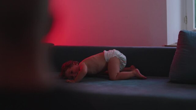 Toddler jumping onto couch during imaginative play, highlighting confidence, physical development and everyday family life