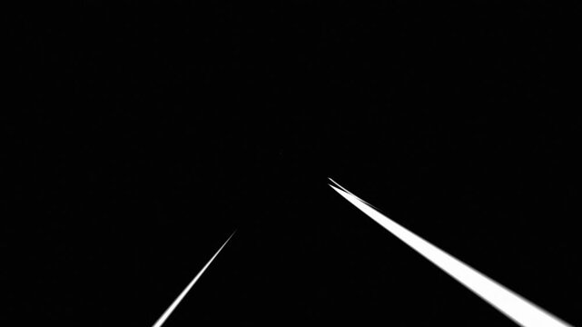 Abstract light streaks moving across dark void. Glowing beam flashes in black background