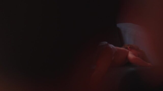 Toddler sliding off couch at home, highlighting gross motor development, confidence and everyday childhood exploration