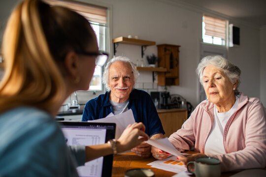 Senior couple meeting with financial advisor at home