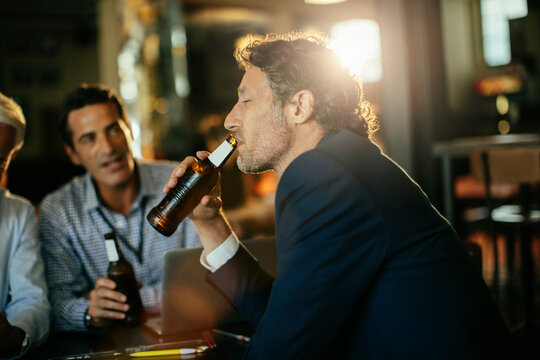 Business colleagues drinking beer at bar after work