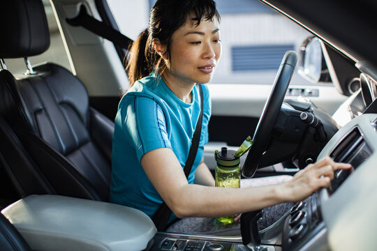 Woman using car touchscreen in vehicle interior