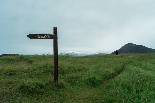 Man stands in the distance on a meadow in Iceland 
