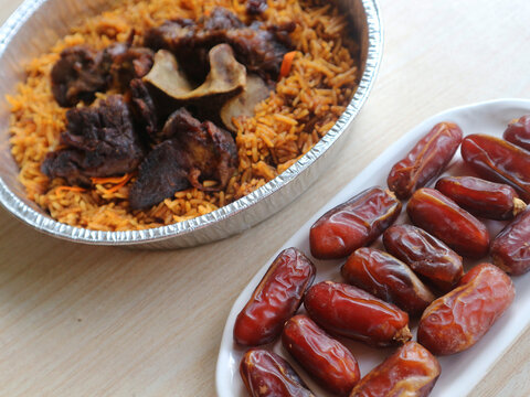 Saudi Arabia_Two servings of lamb kabsah rice bought online and dates