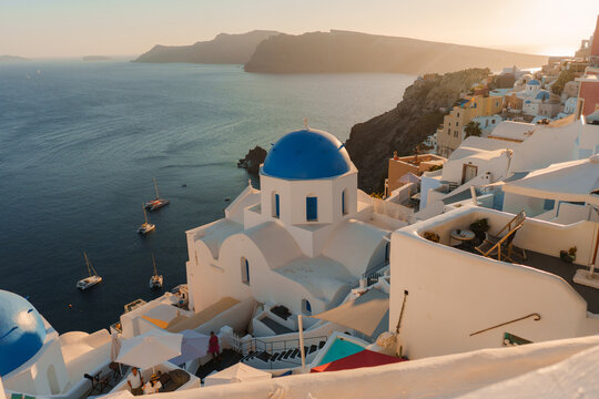 Whitewashed church with blue dome on Santorini island in Greece 