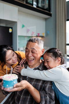 Celebrating their grandfather's birthday with hugs