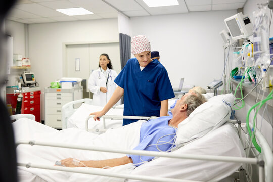 Doc and Nurse With Patient in Room