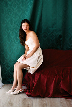 Woman sitting on velvet bench 