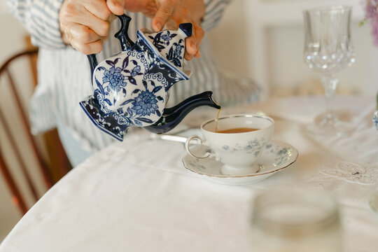 anonymous hand of woman serving  tea 