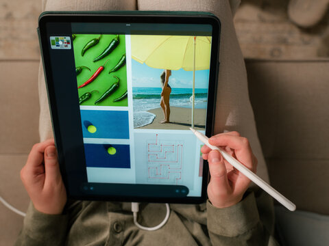 Woman using tablet computer to edit photos 