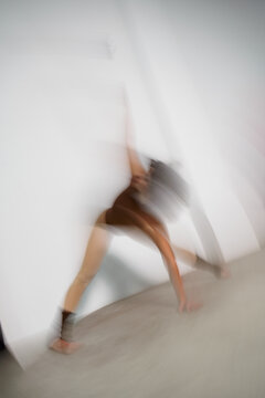 Dancer Performs in Studio Space With a Plain Backdrop