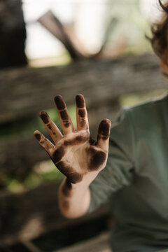 Child's hand stained with ash