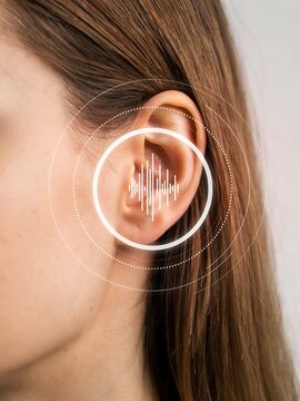 Human ear with digital sound wave visualization. Audio technology concept for hearing aid.