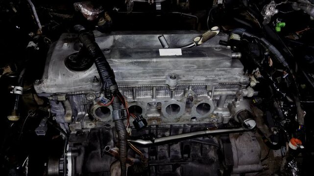 Top view of an open car engine bay with the intake manifold removed.