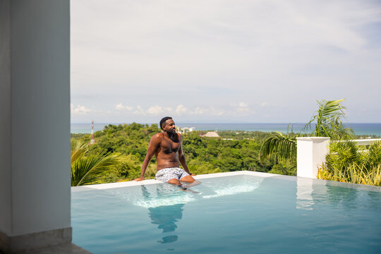Man enjoying a private infinity pool in the Caribbean