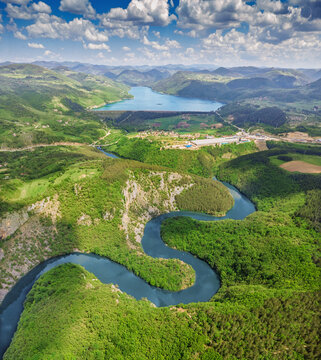 Aerial view of winding Uvac river meanders through lush green forested valley. Nature in Serbia concept.