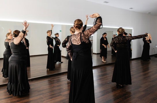 Women learning flamenco dance in a studio group