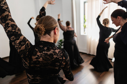 Women engaging in flamenco dance practice in studio