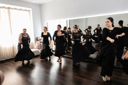 Women learning flamenco dance in studio