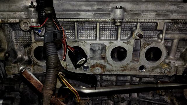 Close-up of open intake ports on a car engine cylinder head.