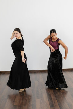 Female dancers performing spanish flamenco during rehearsal