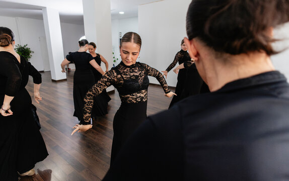 Women performing traditional spanish flamenco dance in a studio