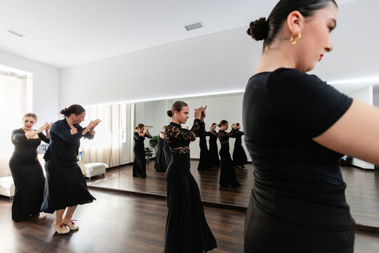 Women learning flamenco dancing during class in studio