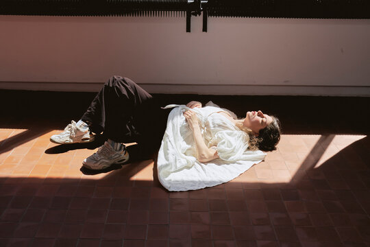 Girl relaxing on the floor in a studio during daytime
