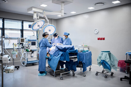 Medical team performing surgery in a modern operating room