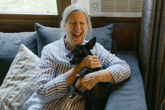 happy laughing woman with her dog 