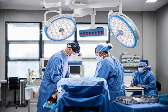 Surgeons perform an operation in a modern surgical theater