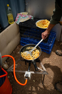 Person frying french fries