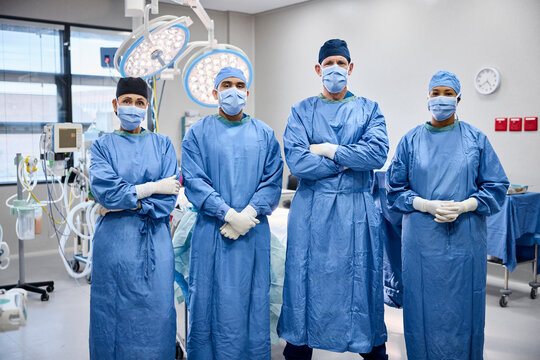 Surgeons stand ready in operating room