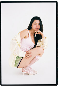 Woman squatting in contemporary fashion 