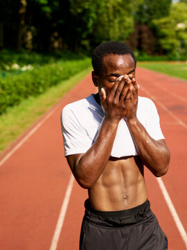 Runner Feels Exhaustion After a Workout on the Track