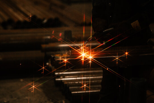 Welder Using Torch on Metal Fabrication in Workshop