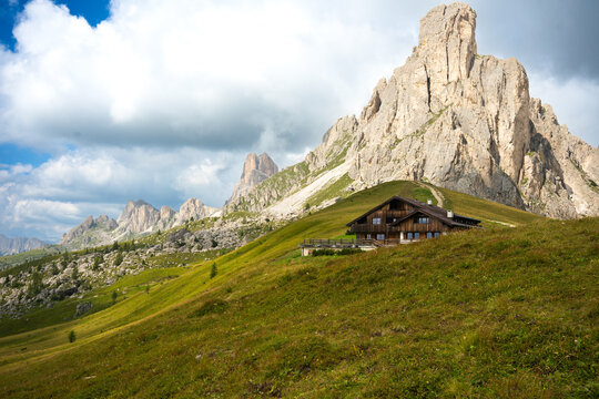 Traditional Alpine Mountain Hut Beneath Dramatic Dolomite Peaks at Passo Giau in the Italian Alps Italy