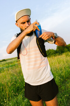 Runner Prepares for a Training Session in a Grassy Field