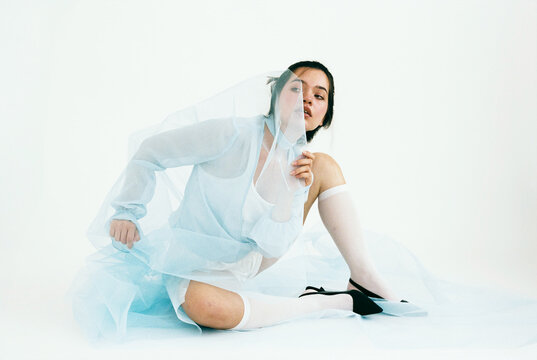 Woman with light blue sheer fabric