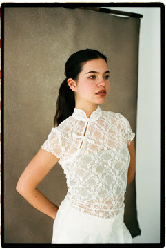 Woman wearing white lace qipao style top