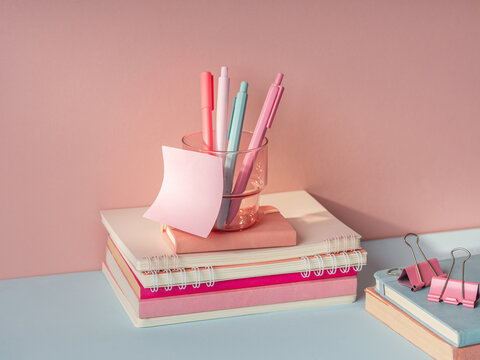 Pastel stationery and notebooks arranged neatly on a desk